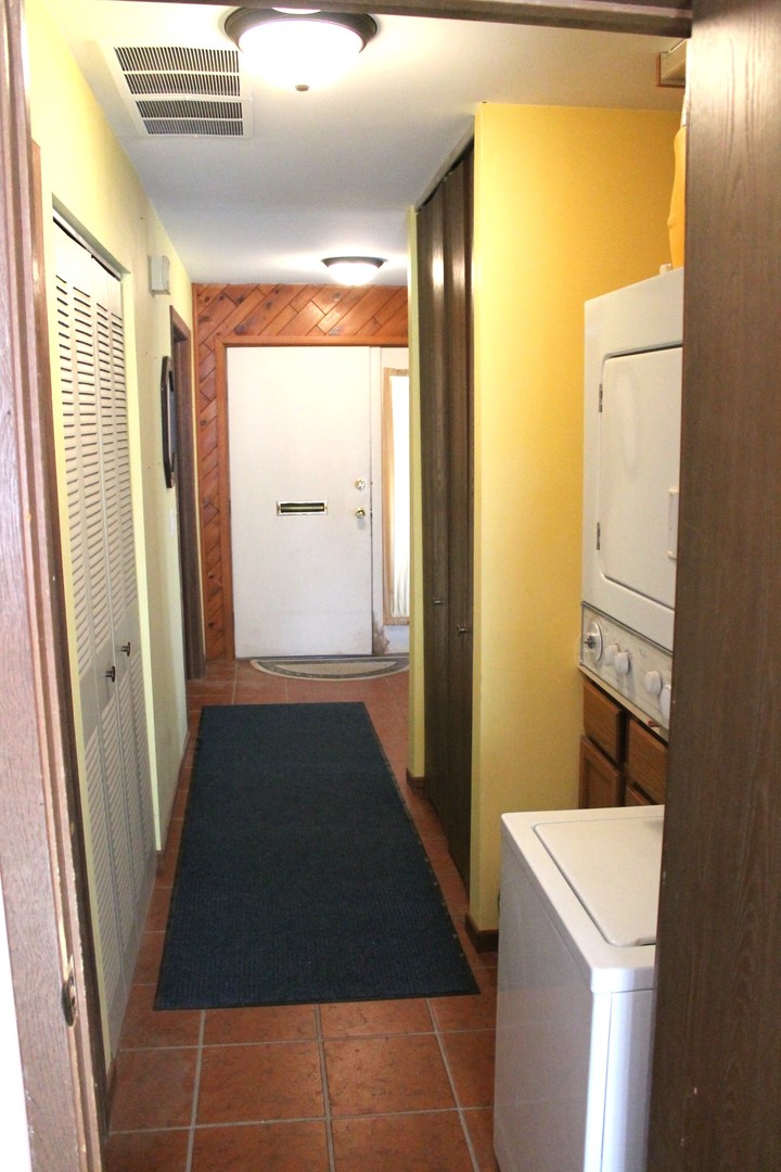 69 White Oaks Road, Unit 69 Fox Lake, IL 60020 - Photo 10 of 18 a view of a hallway with washer and dryer