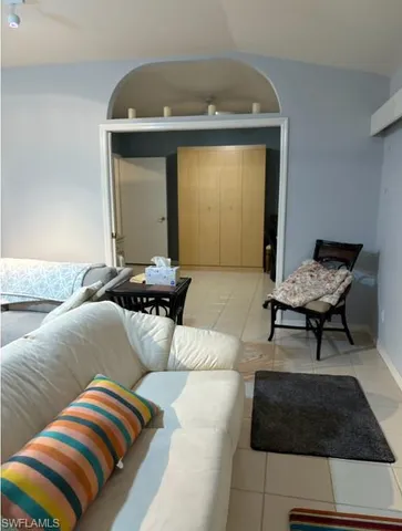 a living room with furniture and a mirror