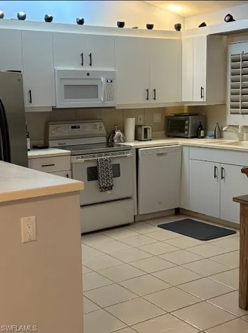 a kitchen with a stove and cabinets