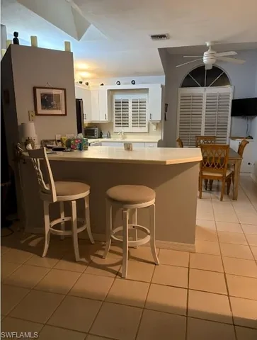 a dining room with furniture and chandelier