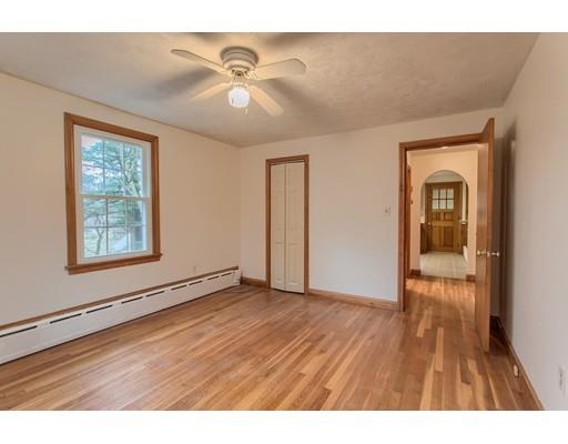 81 Sylvan Road Lancaster, MA 01523 - Photo 12 of 23 a view of an empty room with wooden floor and a window
