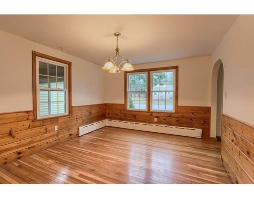 81 Sylvan Road Lancaster, MA 01523 - Photo 7 of 23 a view of an empty room with wooden floor and a window