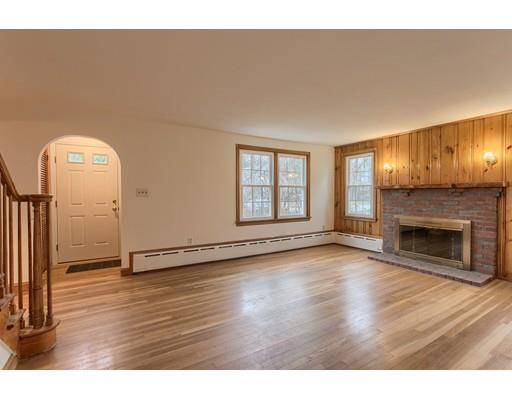81 Sylvan Road Lancaster, MA 01523 - Photo 10 of 23 a view of an empty room with wooden floor fireplace and a window