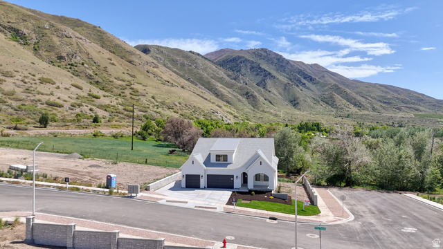 82 East 1900th South Payson, UT 84651 - Photo 2 of 40 Modern farmhouse exterior with a light gray facade, dark gray roofing, and a two-car garage