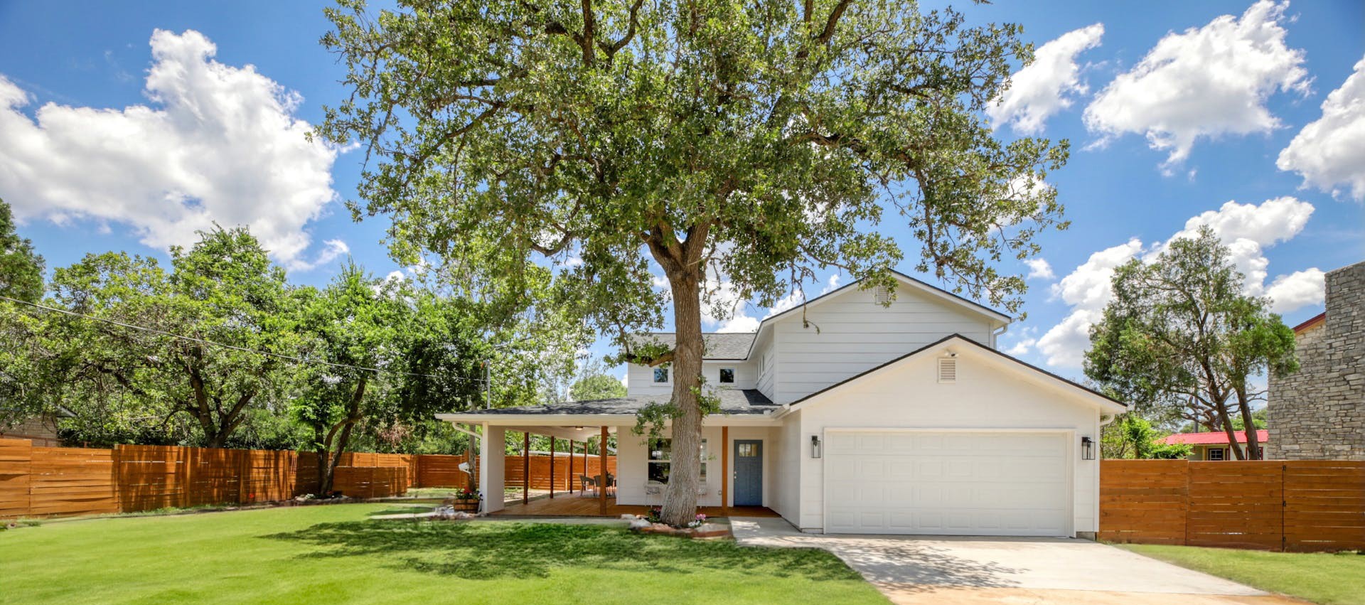 Beautiful large oak tree highlights the large flat yard and wrap around porch!