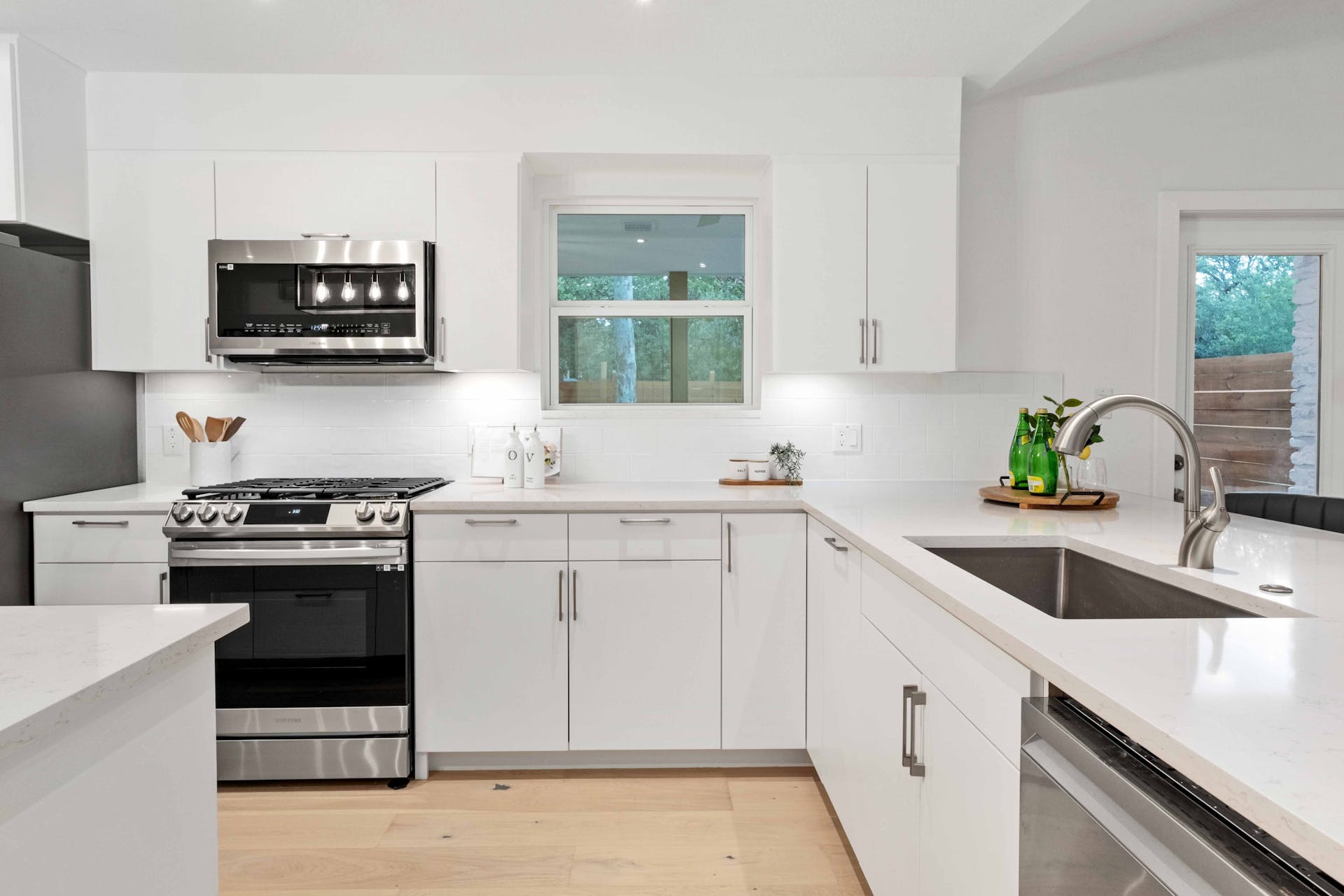 13207 Fencerail Road Manchaca, TX 78652 - Photo 14 of 36 Kitchen with stainless steel appliances, frameless plywood cabinets, and quartz countertops
