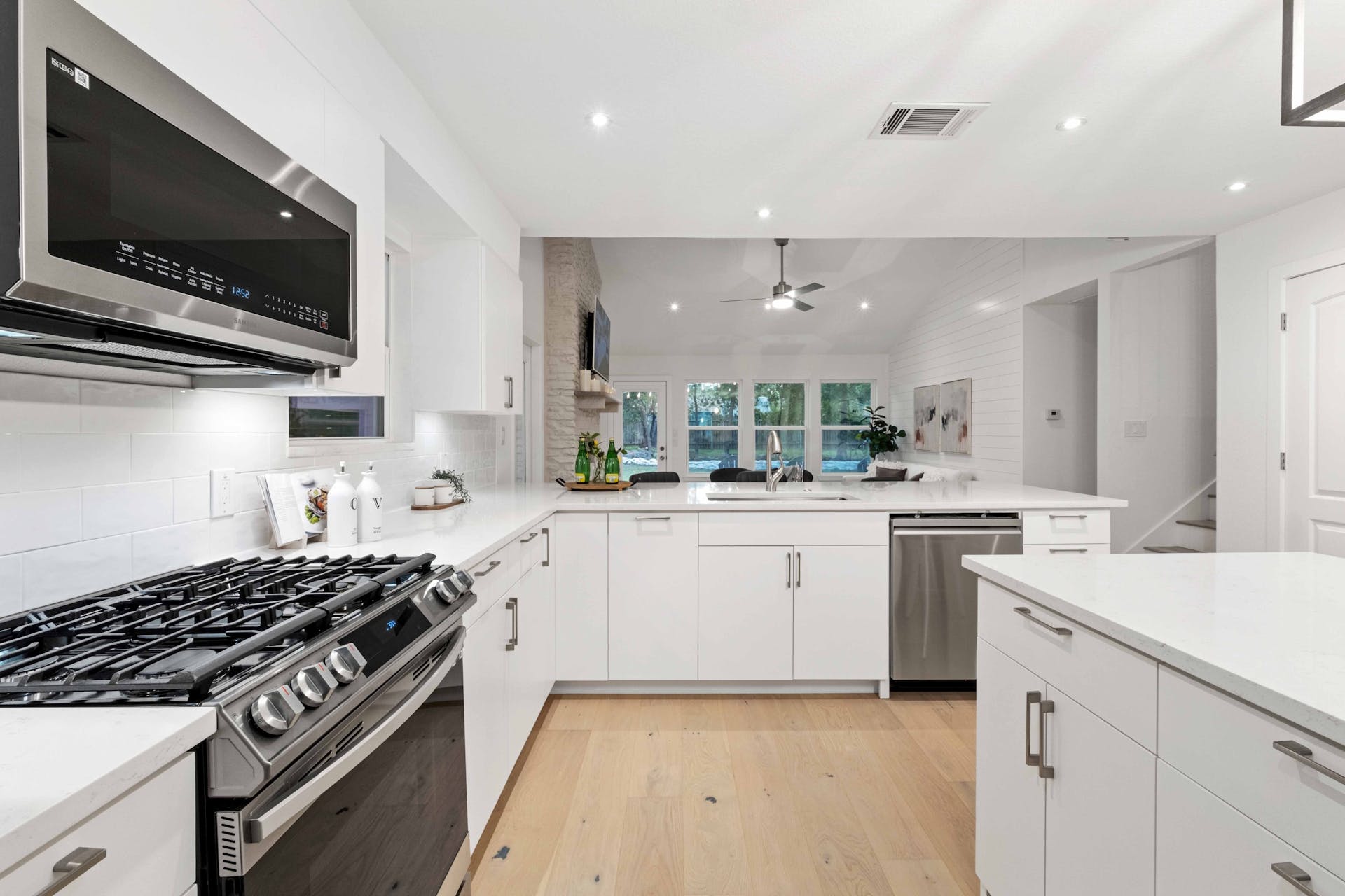 13207 Fencerail Road Manchaca, TX 78652 - Photo 15 of 36 Kitchen with stainless steel appliances, frameless plywood cabinets, and quartz countertops