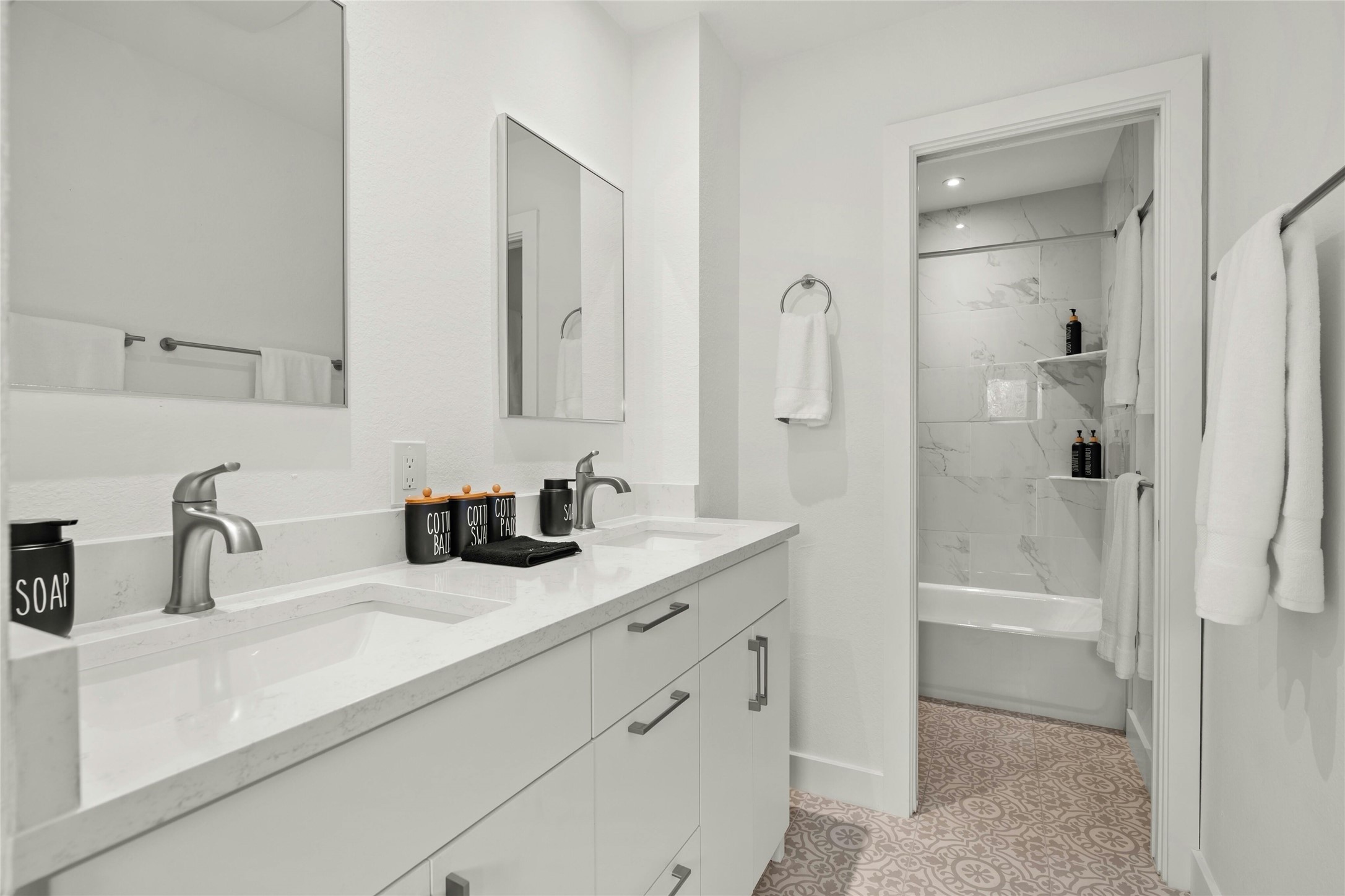 13207 Fencerail Road Manchaca, TX 78652 - Photo 23 of 36 Full bathroom with double vanity, shower / tub combination, and light tile patterned flooring