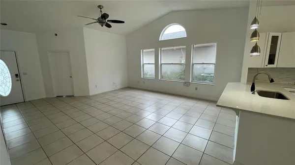 a view of a livingroom with wooden floor and a large window