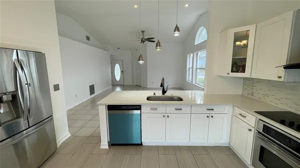 a kitchen with a sink stainless steel appliances and cabinets