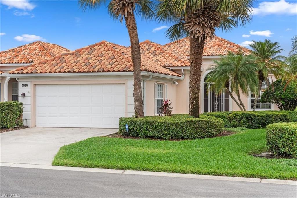 3956 Isla Ciudad Court Naples, FL 34109 - Photo 1 of 31 a front view of a house with a garden