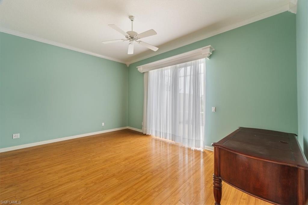 3956 Isla Ciudad Court Naples, FL 34109 - Photo 15 of 31 an empty room with wooden floor and fan
