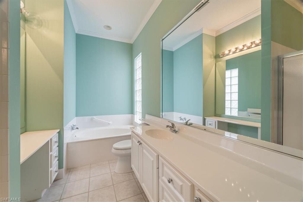 3956 Isla Ciudad Court Naples, FL 34109 - Photo 18 of 31 a bathroom with a double vanity sink mirror and toilet
