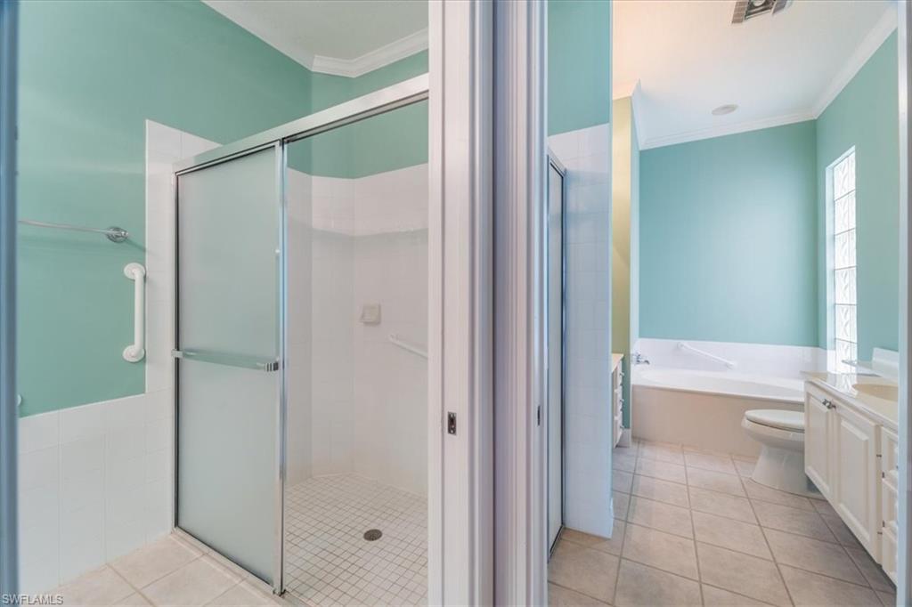 3956 Isla Ciudad Court Naples, FL 34109 - Photo 19 of 31 a bathroom with a bathtub and a shower
