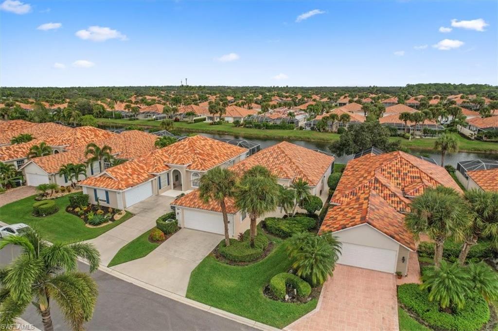 3956 Isla Ciudad Court Naples, FL 34109 - Photo 2 of 31 an aerial view of a house with a lake view