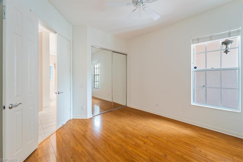 3956 Isla Ciudad Court Naples, FL 34109 - Photo 23 of 31 a view of empty room with wooden floor and fan