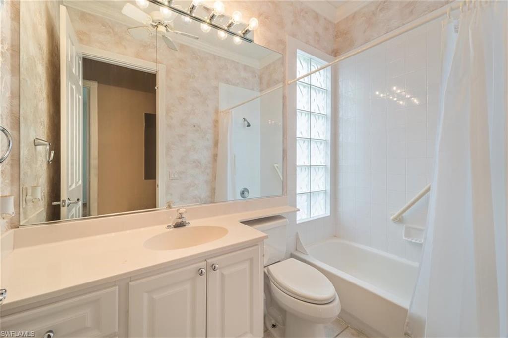 3956 Isla Ciudad Court Naples, FL 34109 - Photo 24 of 31 a bathroom with a bathtub shower sink vanity mirror and toilet