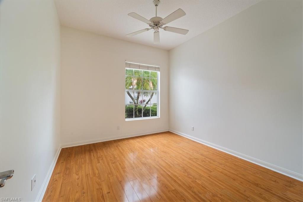 3956 Isla Ciudad Court Naples, FL 34109 - Photo 25 of 31 an empty room with a window and a ceiling fan