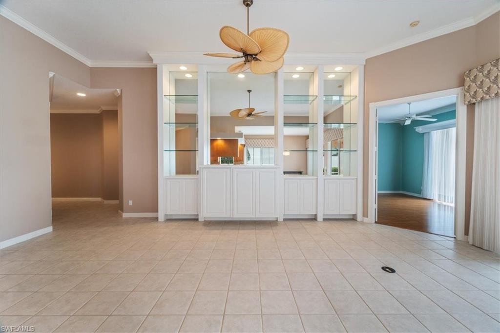 3956 Isla Ciudad Court Naples, FL 34109 - Photo 7 of 31 a view of a livingroom with a chandelier furniture and windows