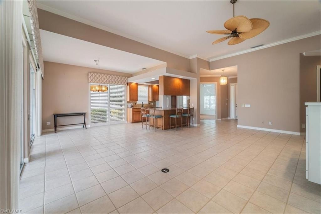 3956 Isla Ciudad Court Naples, FL 34109 - Photo 8 of 31 a view of a livingroom with furniture and a ceiling fan