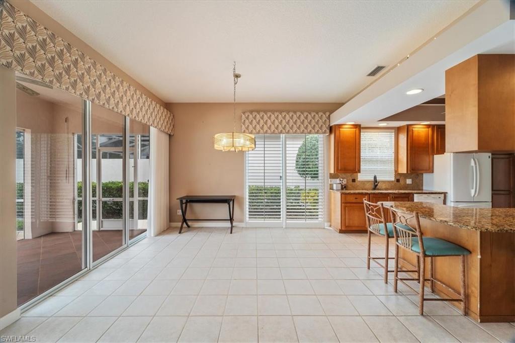 3956 Isla Ciudad Court Naples, FL 34109 - Photo 9 of 31 a room with lots of table and chairs