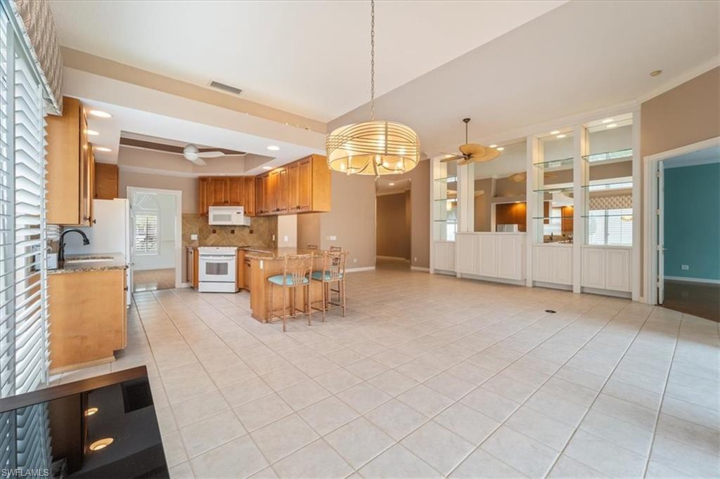 3956 Isla Ciudad Court Naples, FL 34109 - Photo 10 of 31 a view of a living room and dining room