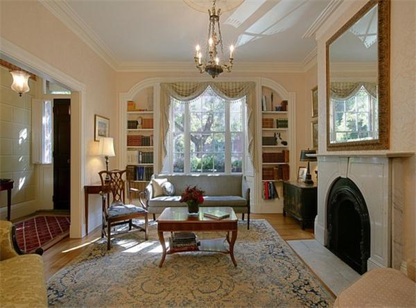 a living room with furniture a chandelier and a fireplace