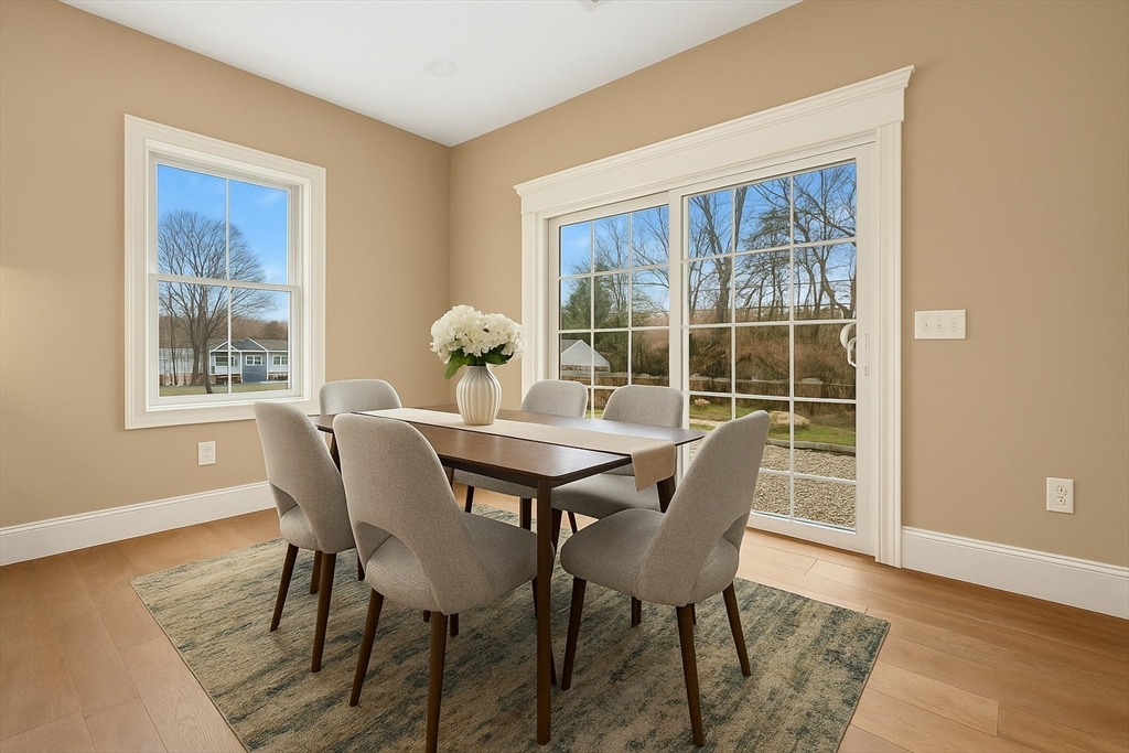 2 A Wilson Road, Unit A Millbury, MA 01527 - Photo 7 of 26 a dining room with furniture a rug and wooden floor
