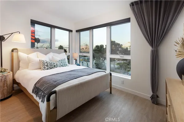 a bedroom with a bed and a large window