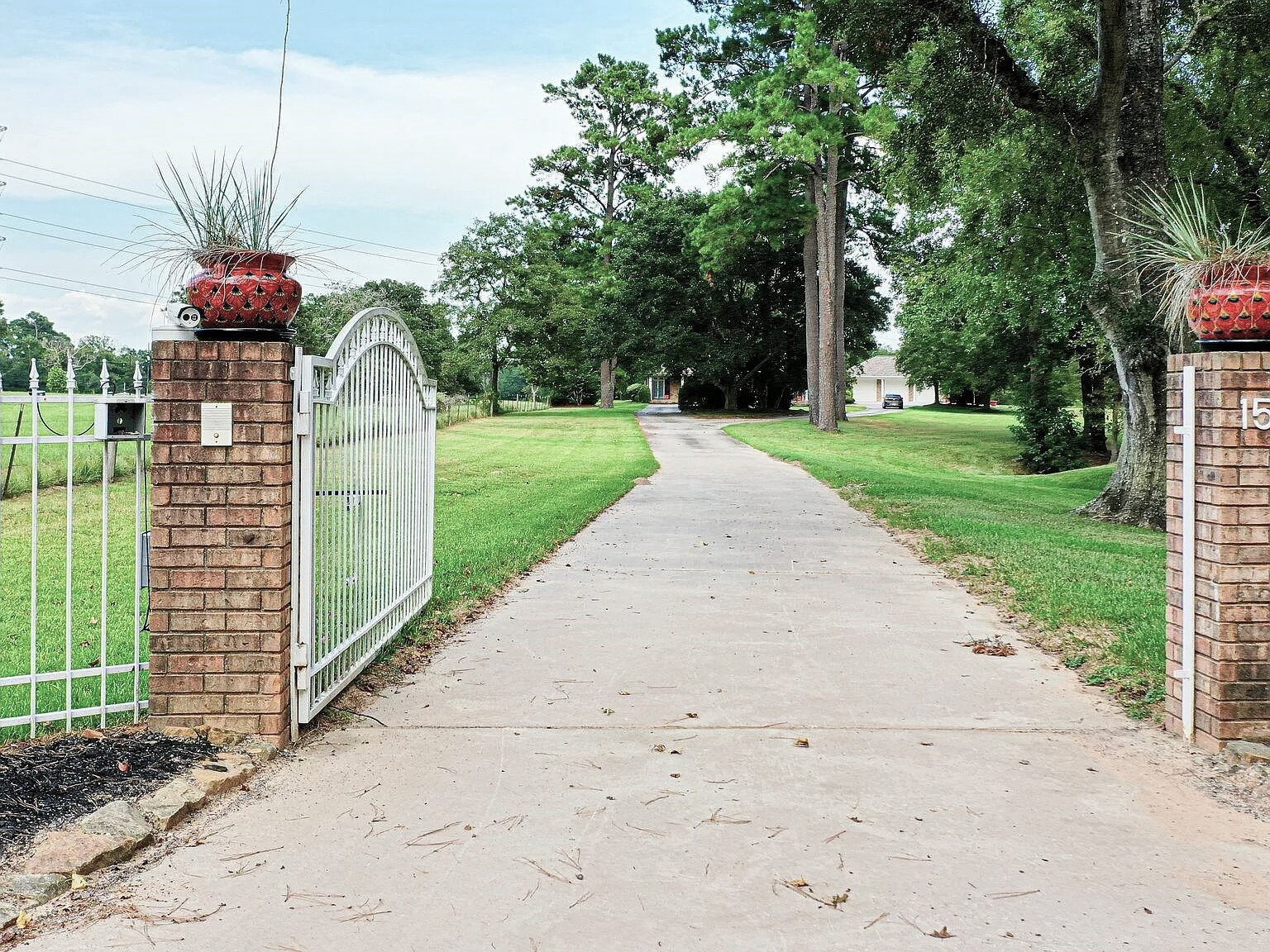 1548 Virgie Community Road Magnolia, TX 77354 - Photo 2 of 50 a front view of a house with a yard and potted plants