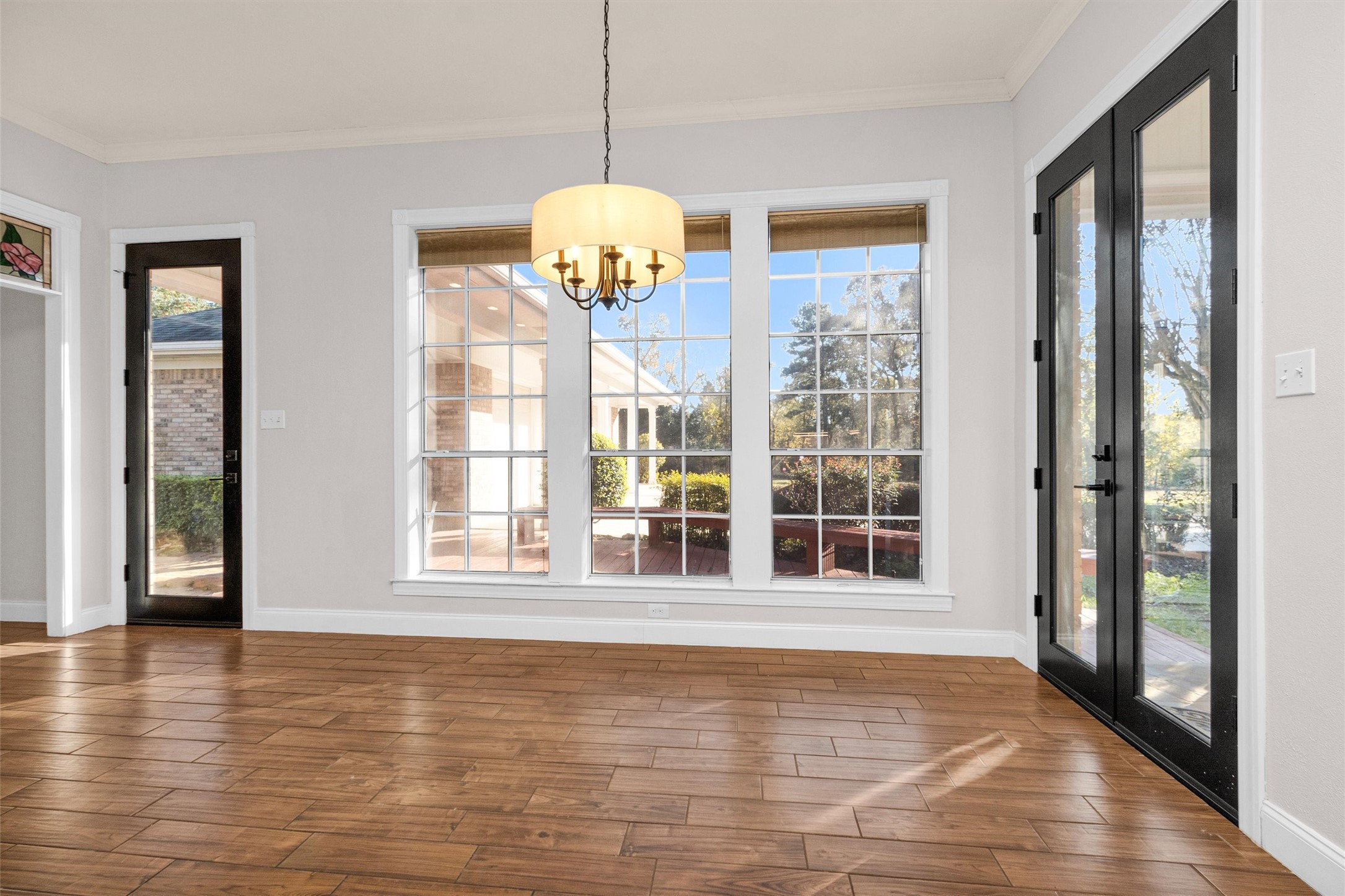 1548 Virgie Community Road Magnolia, TX 77354 - Photo 24 of 50 a view of an empty room with wooden floor and a window