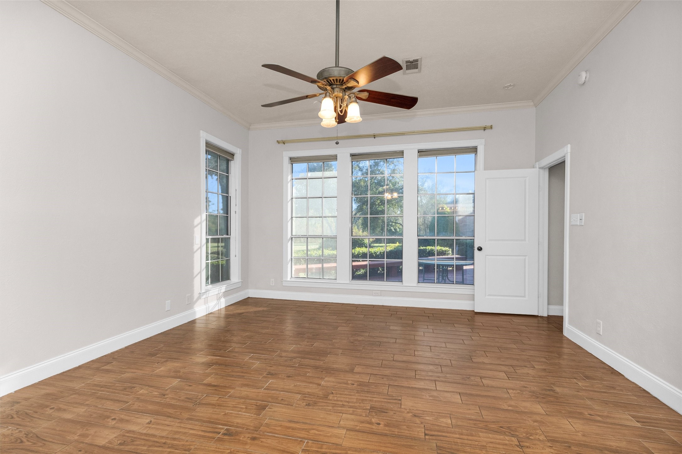 1548 Virgie Community Road Magnolia, TX 77354 - Photo 37 of 50 a view of an empty room with window and wooden floor