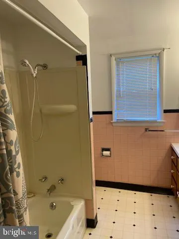 a bathroom with a window sink and shower