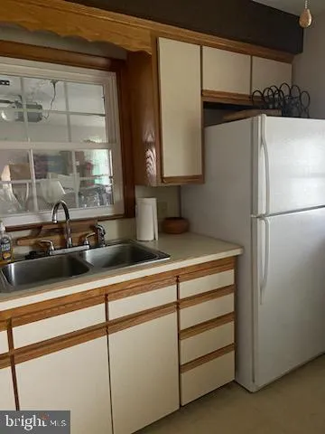 a kitchen with a refrigerator and a sink
