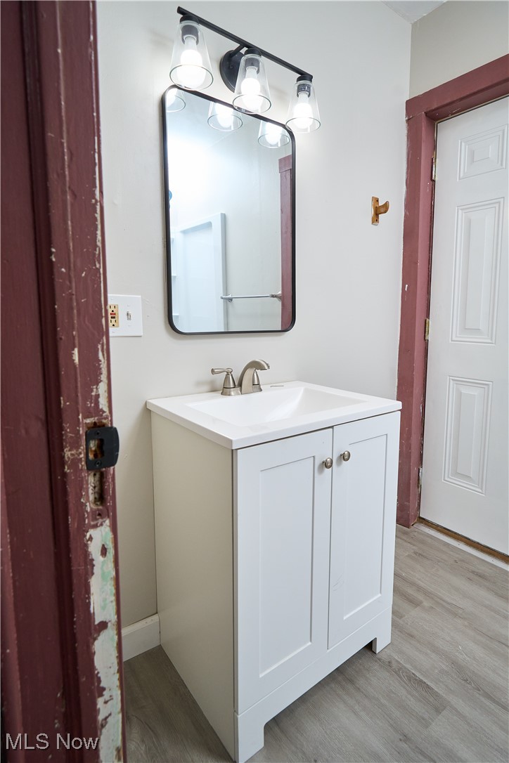 5432 State Road Parma, OH 44134 - Photo 32 of 47 Half bath with vanity and light wood-style flooring