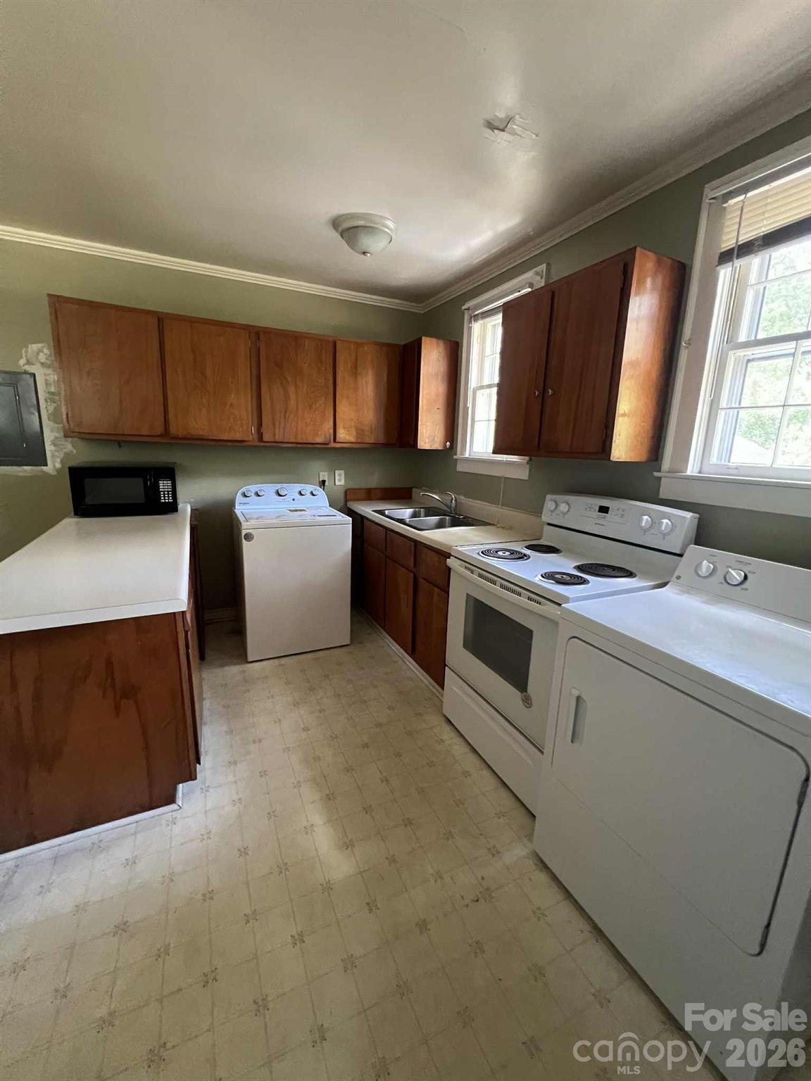 651 Still Street Chester, SC 29706 - Photo 15 of 30 a kitchen with stainless steel appliances granite countertop a stove a sink and a refrigerator