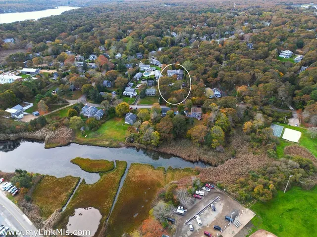 an aerial view of a house with a backyard