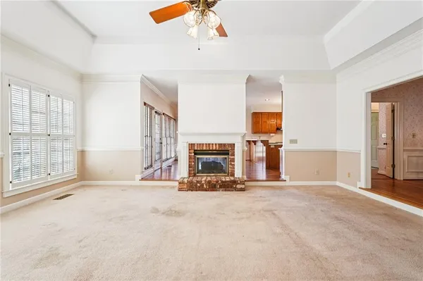 a living room with stainless steel appliances kitchen island granite countertop furniture and a refrigerator