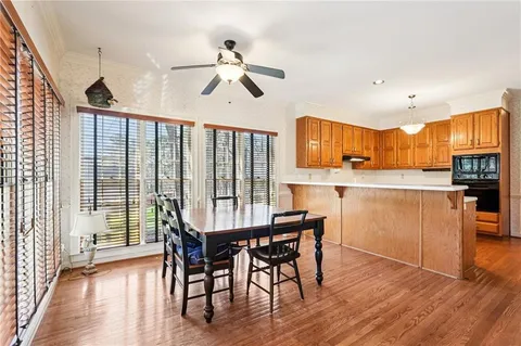 a view of a dining room with furniture wooden floor and chandelier