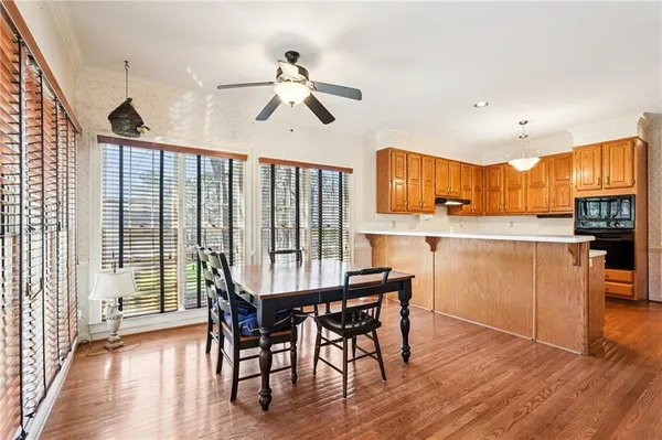 a view of a dining room with furniture wooden floor and chandelier