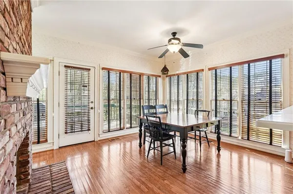 a view of a dining room with furniture and wooden floor