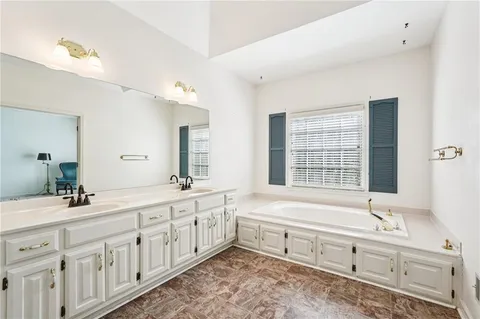 a kitchen with granite countertop a refrigerator and a sink