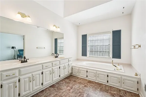a kitchen with granite countertop a refrigerator and a sink
