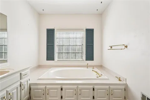 a kitchen with stainless steel appliances a refrigerator a stove and white cabinets