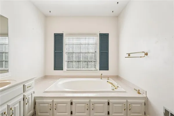 a kitchen with stainless steel appliances a refrigerator a stove and white cabinets