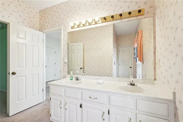 a bathroom with a granite countertop sink a mirror a shower and a bathtub