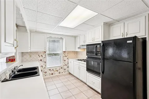 a view of a house with a small yard and plants