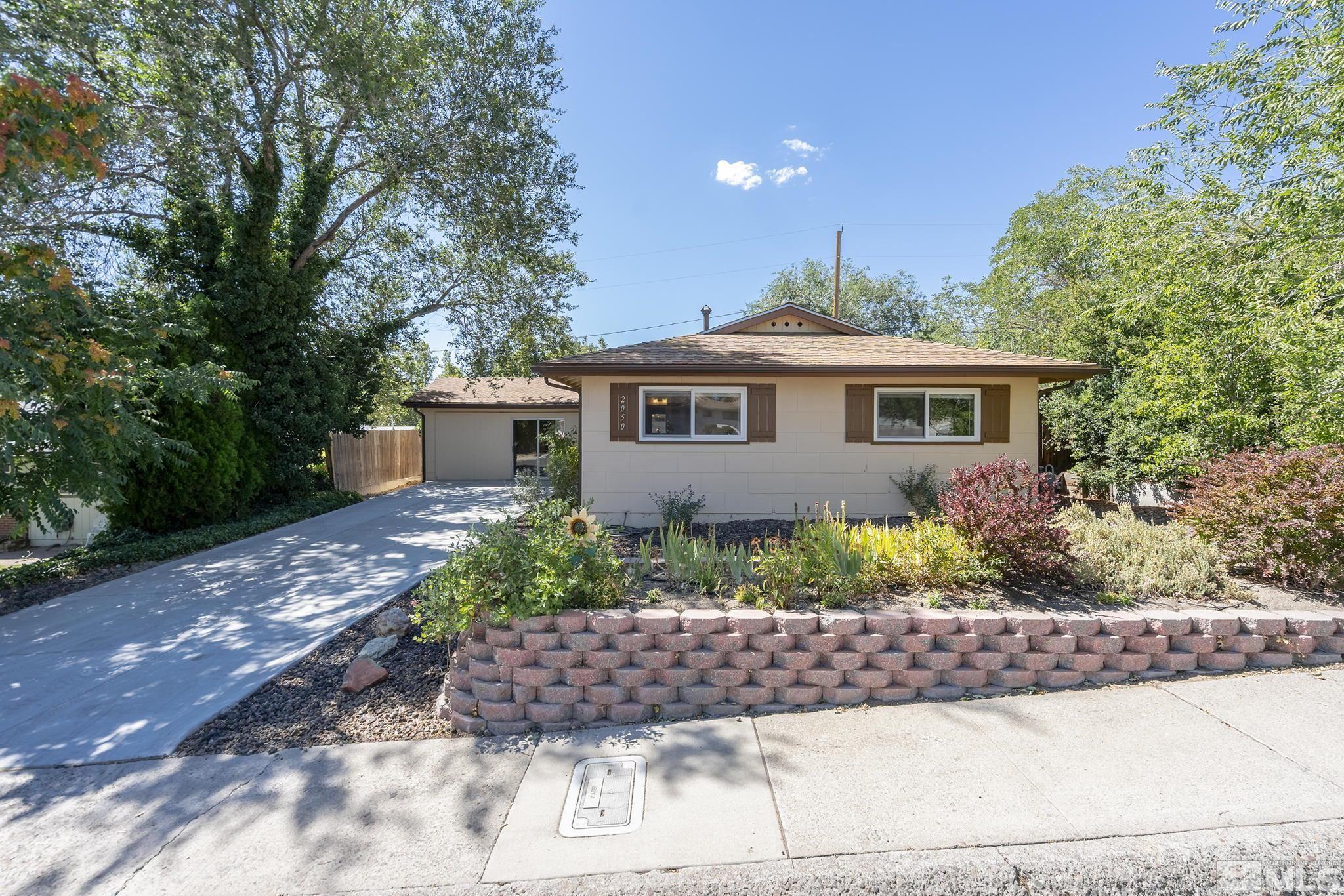 2050 Brisbane Avenue Reno, NV 89503 - Photo 1 of 24 a front view of a house with garden
