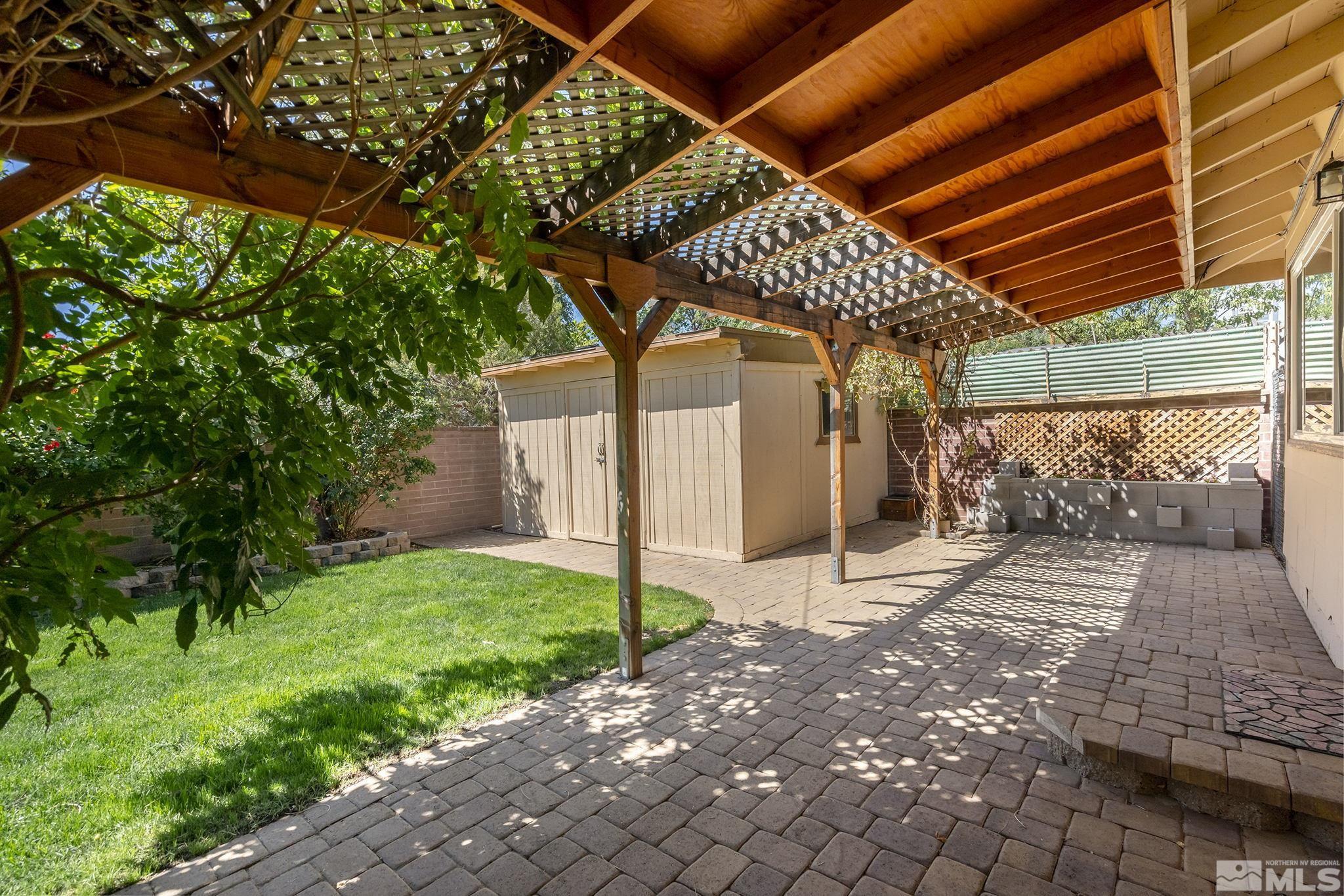 2050 Brisbane Avenue Reno, NV 89503 - Photo 14 of 24 a view of a backyard with a large tree