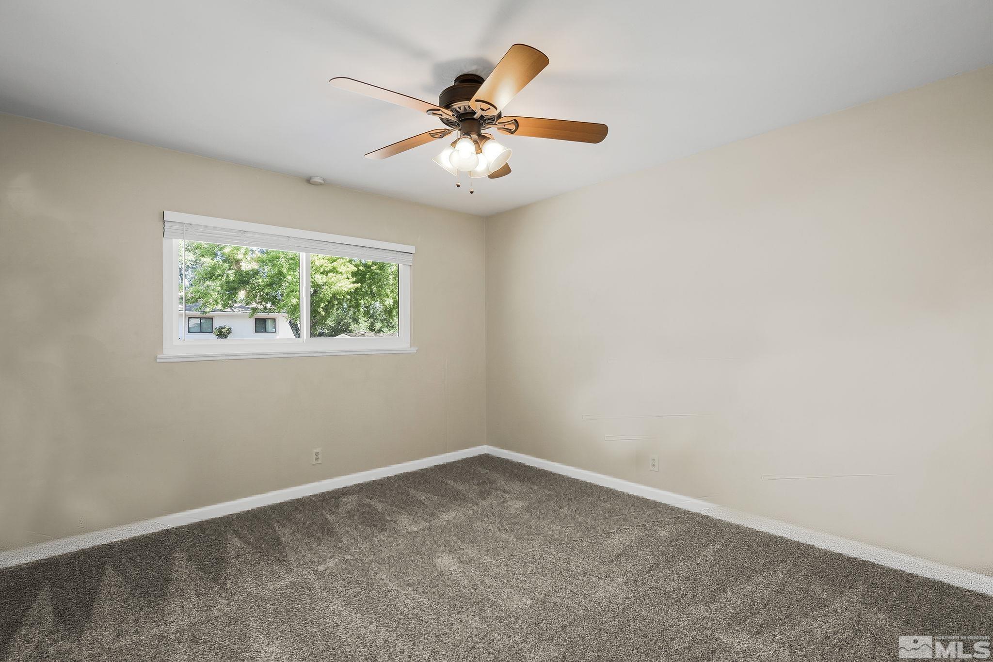 2050 Brisbane Avenue Reno, NV 89503 - Photo 18 of 24 an empty room with windows and fan